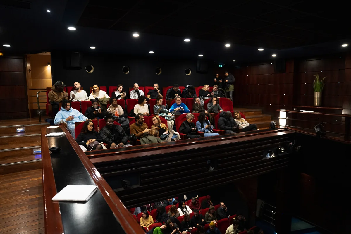The audience seated in the cinema, seen from the balcony
